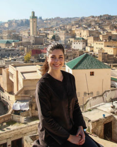 Girl sitting on rooftop overlooking Morocco