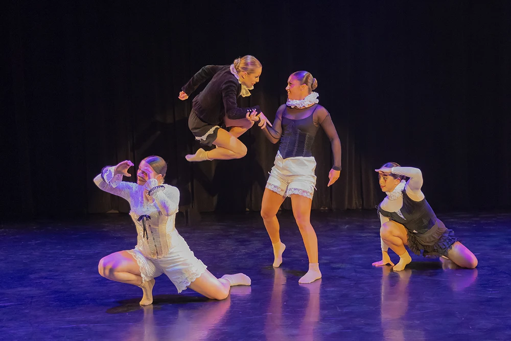 Four dancers, dressed in clown-inspired costumes