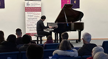 Alex Wong plays on a grand piano during a recital