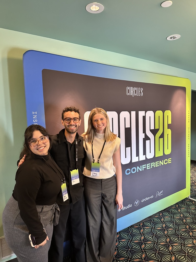 Three Circles Conference attendees smile for a photo in front of a colorful Circles 2026 Conference backdrop.