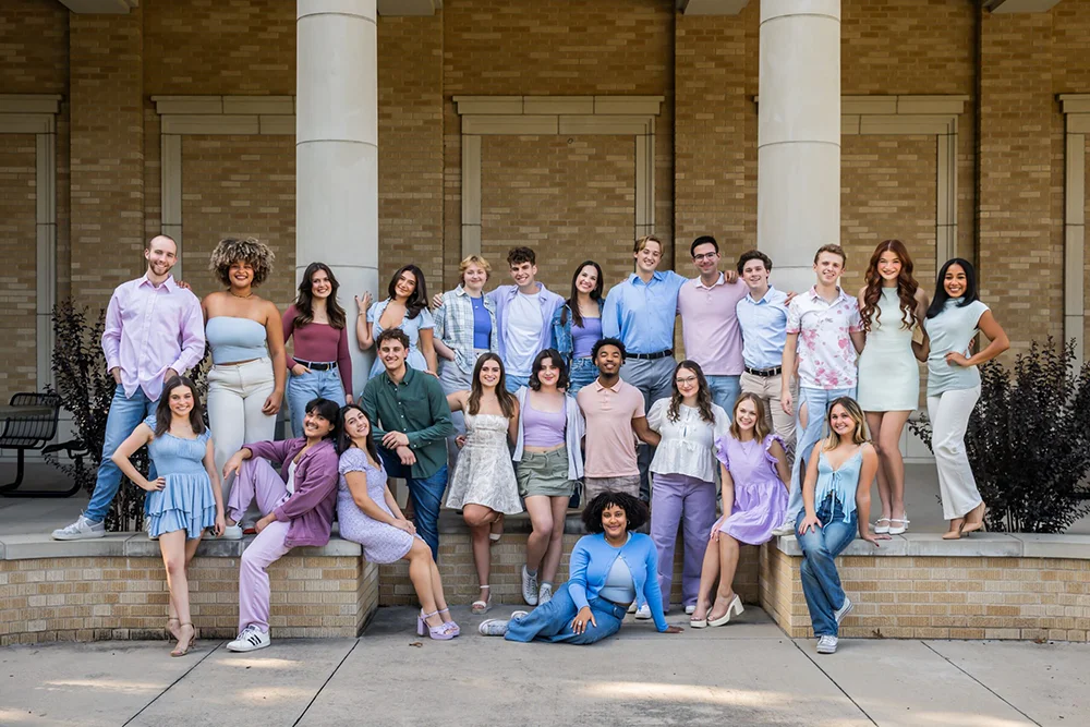 A group of rising senior Theatre TCU students gather in front of Ed Landreth Hall