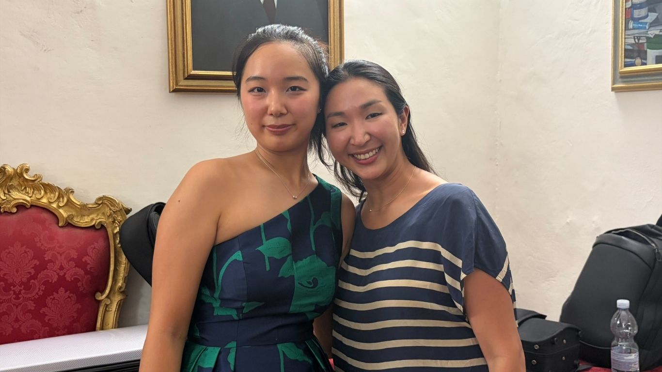 June and her mom smile for a photo together while traveling in Italy.