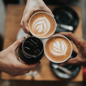 People toasting their coffee cups.