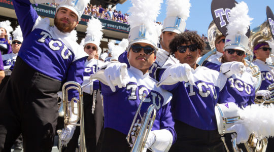 The TCU marching band cheers for the Horned Frogs