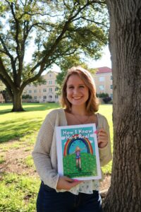 Amanda Pretico holding the book “How I Know He’s Real” by Charlotte Woodford.