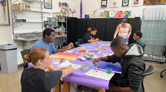 TCU students guide Everman students in creating art history-inspired paintings and teach them to use their skills to make items for sale in their campus enterprise.