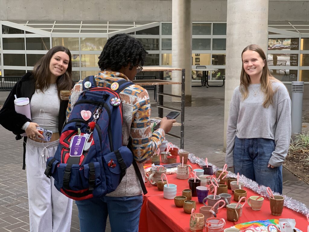 As part of a guided study with Powell, Hackman (right) worked closely with the ceramics and advanced ceramics classes to organize the ceramics sale.