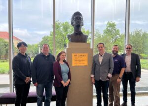 Group photo of Stephen Bates, Amanda Goodwin, Corey Hale, Chad Jung, Alex Moore, and SeungChan Lee gathered around the Van Cliburn sculpture in the TCU Music Center lobby.