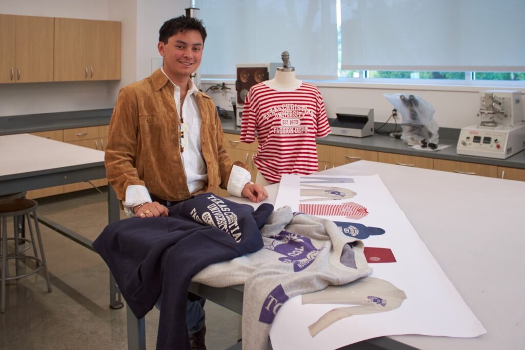 Department of Fashion Merchandising junior Kalei’o Hernandez showcases his capsule collection in a classroom in the Fine Arts Building.