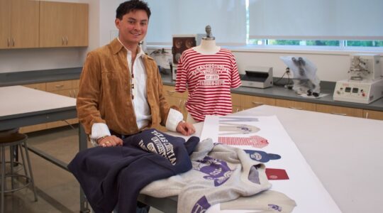 Department of Fashion Merchandising junior Kalei’o Hernandez showcases his capsule collection in a classroom in the Fine Arts Building.