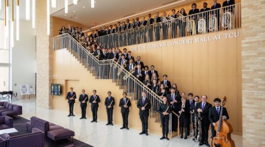 Group photo of the TCU Wind Ensemble in the Megan and Victor Boschini Music Center.